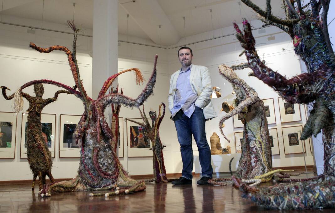 String Theory curator Glenn Barkley at Wollongong Art Gallery with works by the the Tjanpi Desert Weavers. Picture: ANDY ZAKELI