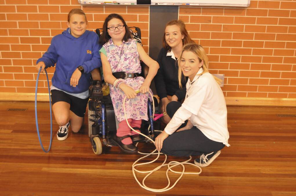 Kayla Gibson helped organise a fundraiser for the Make-A-Wish Foundation. She is pictured with fellow Kiama High students Taylor-Lee Byrne, Briannan Bugden and Brooke Bugden. Picture: BRENDAN CRABB
