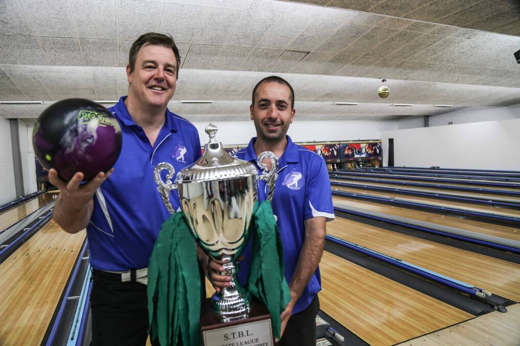 Andrew Frawley with Jamie Kyriacou and the NSW championship trophy the Shellharbour Sharks won in their inaugural tenpin bowling season. Picture: GEORGIA MATTS