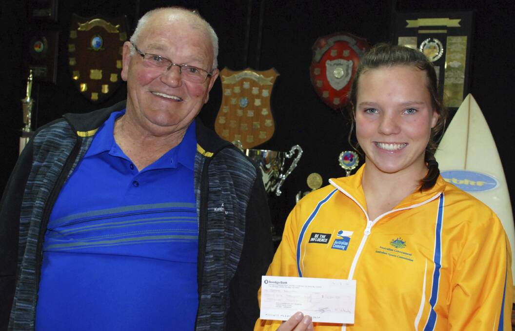 Shellharbour Sports Assistance Fund chairman Don Briggs and 16-year-old kayaker Jayde Bagnall with the cheque that will assist her with the costs of attending the Olympic Hopes regatta in Slovakia. Picture: DAVID HALL