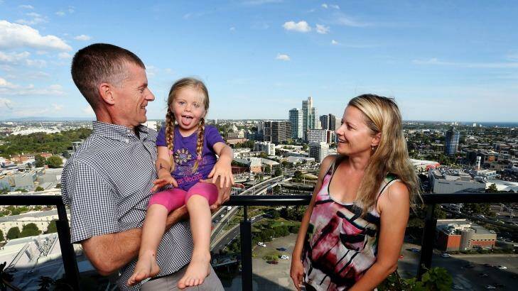 Marton Sadler with his wife Agata and child Olivia in their Southbank high-rise apartment. Photo: Paul Jeffers