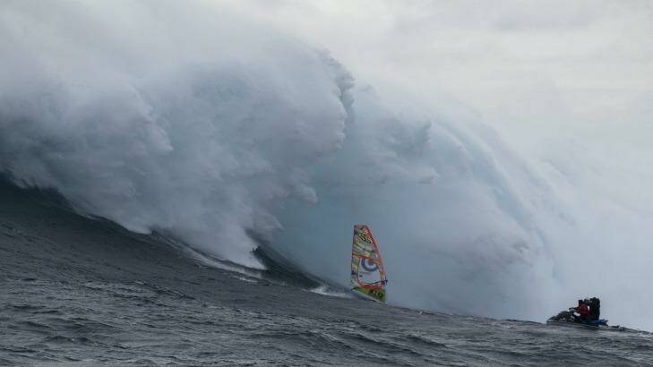 Chased by a monster.  Alastair McLeod rides the Eddystone Rock/Pedra Branca wave  Photo: Chris Carey/Red Bull