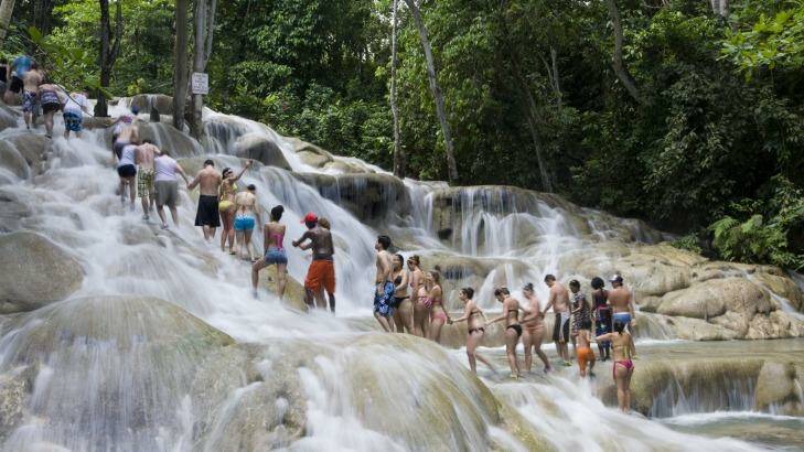 Escorted groups climb the Dunn's River Falls in Jamaica.  Photo: Holger Leue