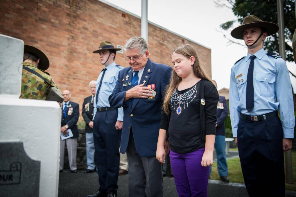 Barry Young with his granddaughter, Abi Cathbert, at the Shellharbour Village Anzac Dawn Service. Picture: ALBEY BOND More pictures at kiamaindependent.com.au