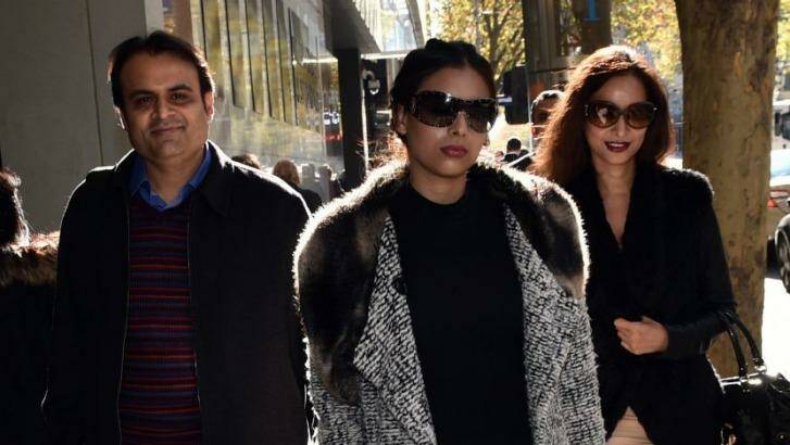 Pankaj Oswal (left) and his wife Radhika (right) and daughter leave court in Melbourne. Photo: JULIAN SMITH