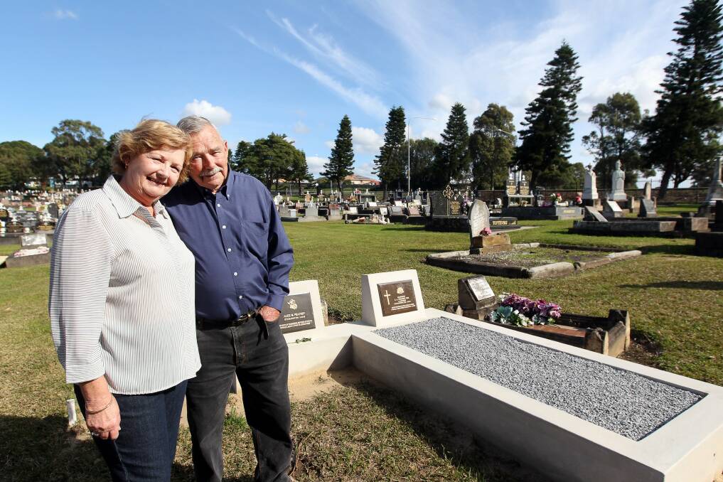 Kay McKenna and her brother Noel Peachy at Shellharbour Cemetary near the grave of their grandfather Fred Peachey, a WWI hero. A memorial built by the War Graves Commission will be dedicated on Sunday. Picture: SYLVIA LIBER