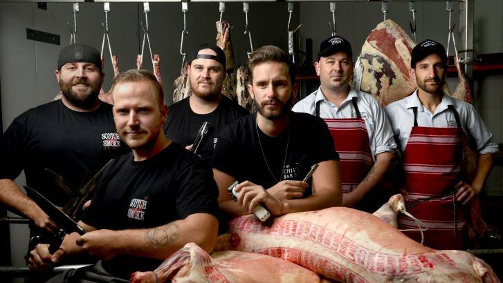 Scotch & Smoke barbecue team's Nick Cooper, Scott Windon, Brad Johnston with barber Eden Worthington and Australian Meat Emporium butchers Mark Fuda and Adam Carlson. All will compete at Meatstock this weekend.  Photo: Steven Siewert