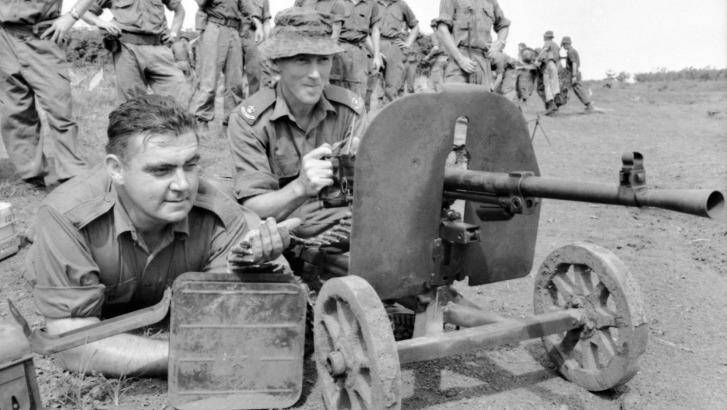 Jack Kirby (left), and Harry Smith test-fire a Goryunov SG43 7.62 x 54mmR Soviet-made Chinese communist heavy machinegun captured at Long Tan. 
 Photo: Courtesy of the Australian War Memorial