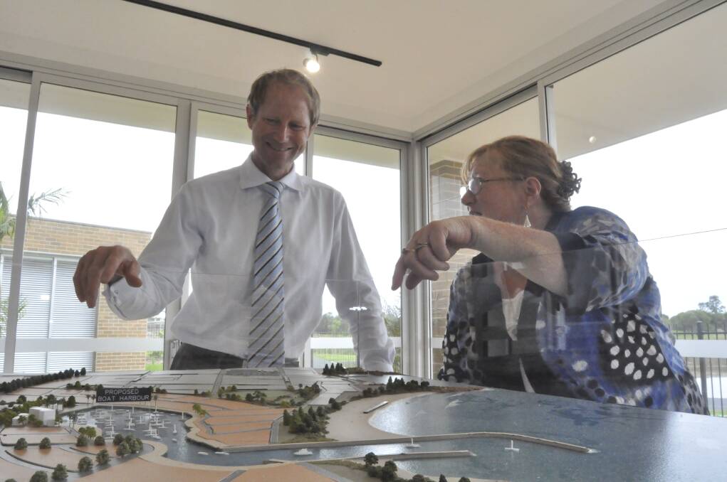 Australand development director Glenn Colquhoun and Shellharbour Mayor Marianne Saliba look over some of the finer details proposed for the area surrounding the Shell Cove marina. Picture: ELIZA WINKLER