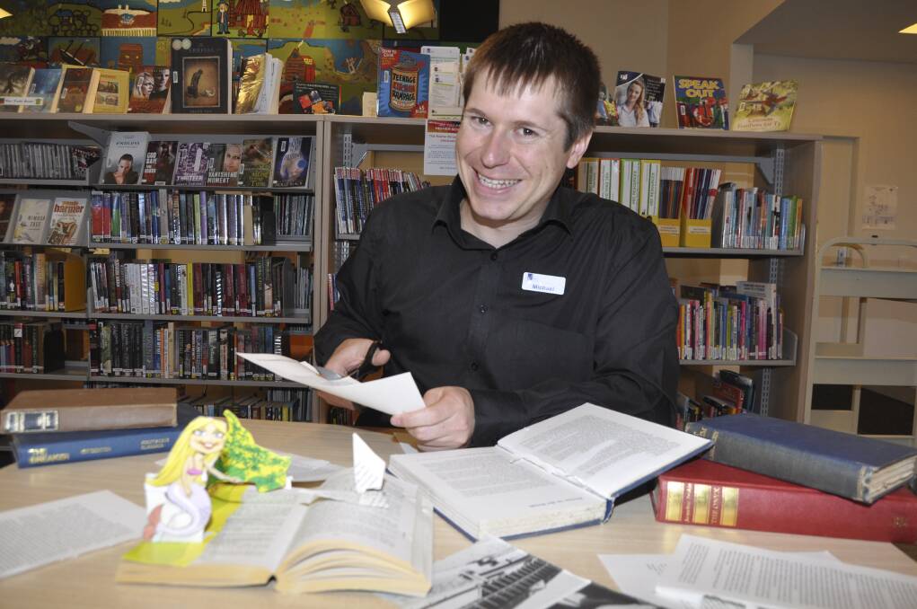 Kiama Library's Michael Dalitz making a book sculpture, for a competition to be held in conjunction with Book Week. Picture: DAVID HALL