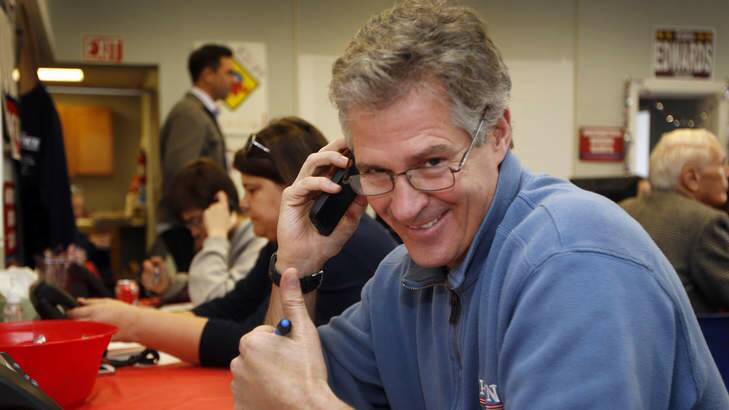 New Hampshire Republican Senate candidate Scott Brown gives a thumbs up as he calls voters on election day from the Republican field office. Photo: AP