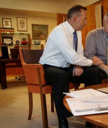 On Tuesday, Abbott and Hockey took part in a contrived photo opportunity pretending to go over drafts. Photo: Andrew Meares