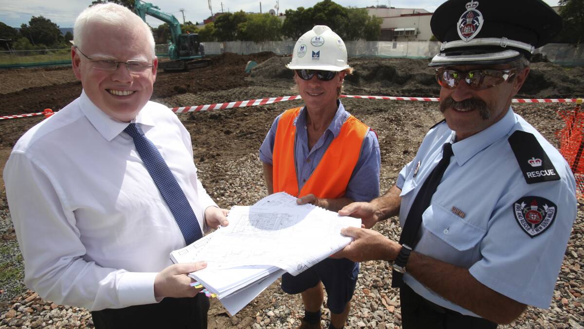 Member for Kiama Gareth Ward, site supervisor Craig Haddon and Fire & Rescue NSW duty commander for the Illawarra John Hawes look at the plans for the new Albion Park fire station. Picture: DANIELLE CETINSKI