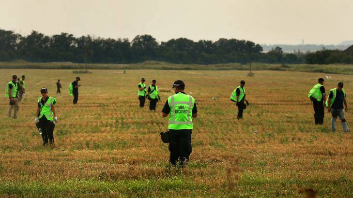 Australian police search the fields for human remains with their Malaysian and Dutch counterparts. Photo: Kate Geraghty