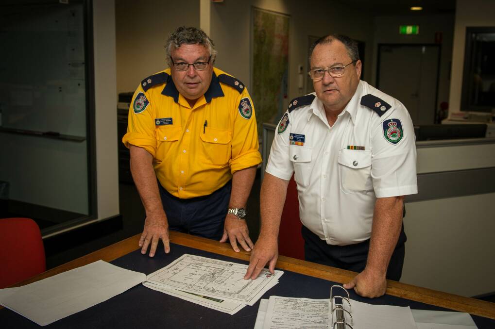 Illawarra Rural Fire Service infrastructure officer Donald Bushby and zone manager Richard Cotterill inspect the plans for a new Albion Park Rural Fire Brigade station. Picture: ALBEY BOND
