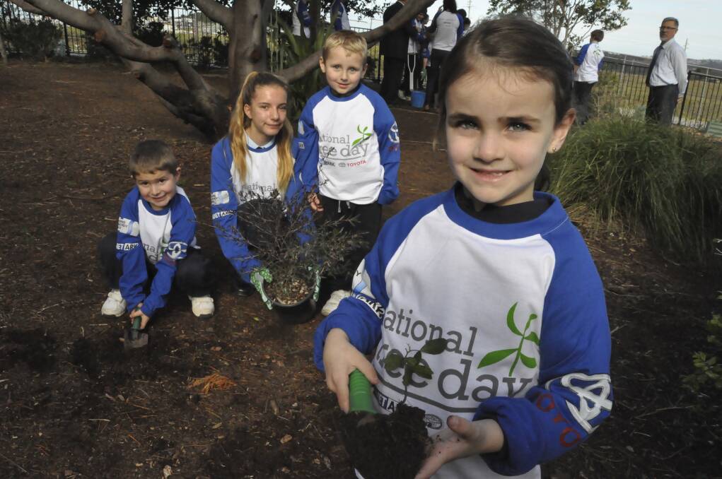  Shellharbour Anglican College students Nathan McIntyre, Eleonore Asquith, Max Tubby and Lucinda Hartenstein get their hands dirty for the environment. Picture Eliza Winkler
