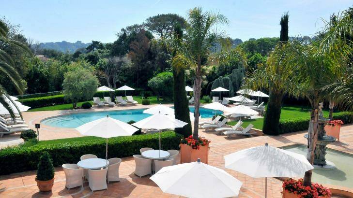 The hotel was once a private villa and still feels like one, surrounded by olive trees and lawns, and reflected in a mosaic-blue swimming pool. Photo: Hotel Imperial Garoupe