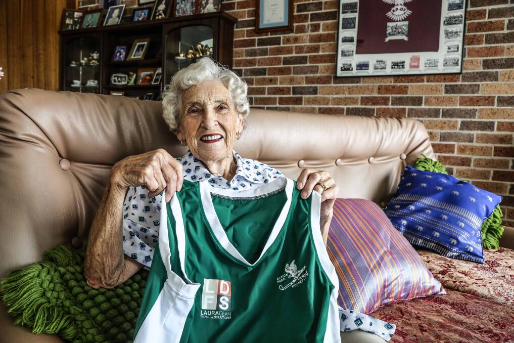 Mary Marley and one of the famous green-and-white uniforms of her beloved Albion Park Hockey Club. Picture: GEORGIA MATTS