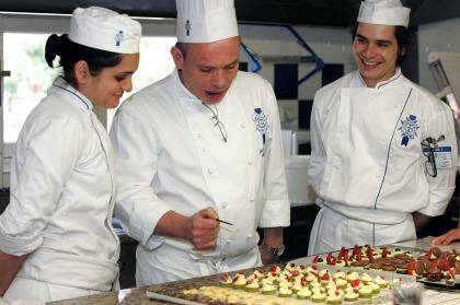 Icing on the cake: A chef tutors students in the finer points of presentation at Le Cordon Bleu International. Photo: Le Cordon Bleu International