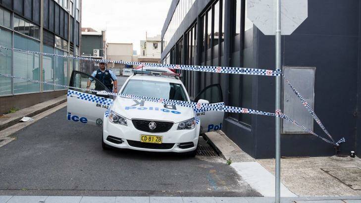 Police guard the laneway where the two boys were arrested in October. Photo: Christopher Pearce