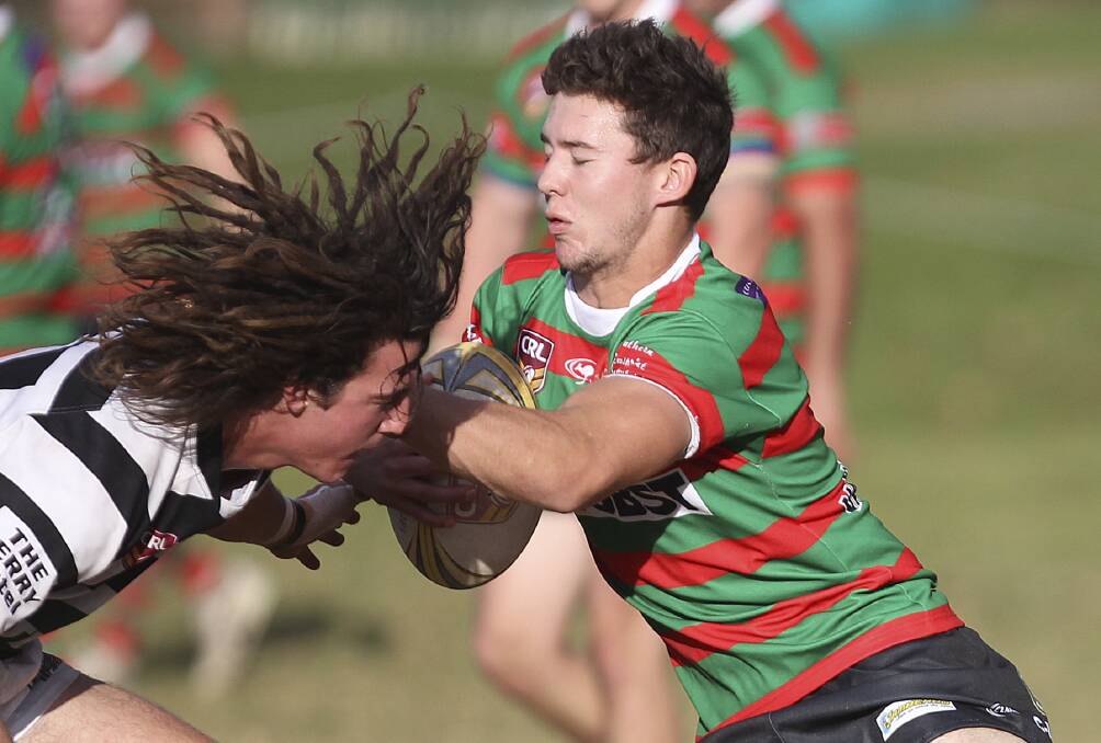 Jamberoo Superoos winger Ben Barnard takes on Berry Magpies' Blake Dryden during Saturday's clash. Barnard's late double helped the home side to a vital 20-10 win at Kevin Walsh Oval. Picture: DAVID HALL