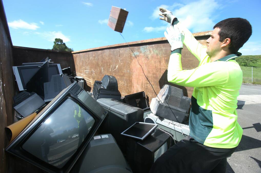 Cody King from Shellharbour Council disposes of e-waste. There is no longer a charge to dispose of these items. A local company, Matthews Metal Management, will perform these duties. Picture: ROBERT PEET