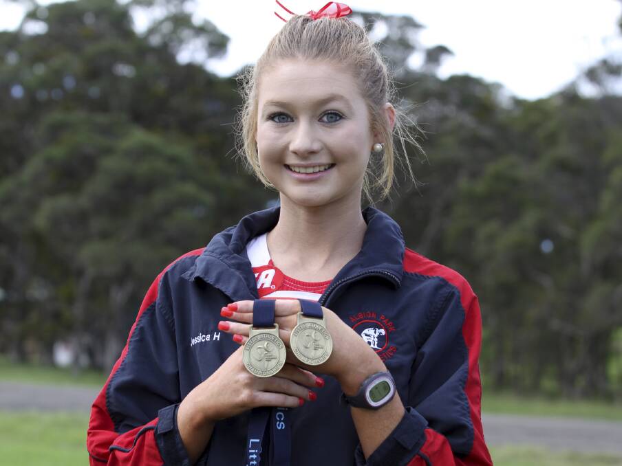 Albion Park speedster Jessica Hull with the two medals she won at the recent State Little As titles. Picture: DAVID HALL