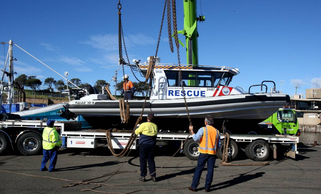 The new marine rescue boat in Belmore Basin. The new boat was lifted off a truck and lowered into the harbour. Picture: ROBERT PEET
