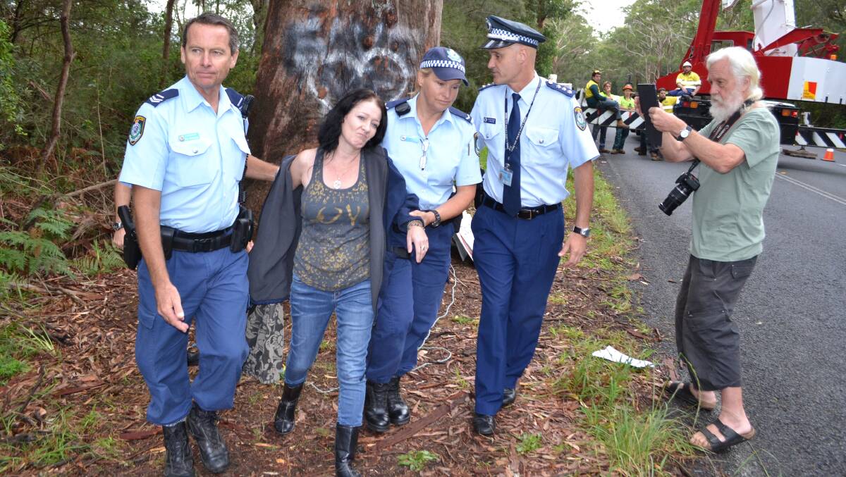 Alison Darling, from Gerroa, is led away by police during the Bum Tree protest on Gerroa Road last week.