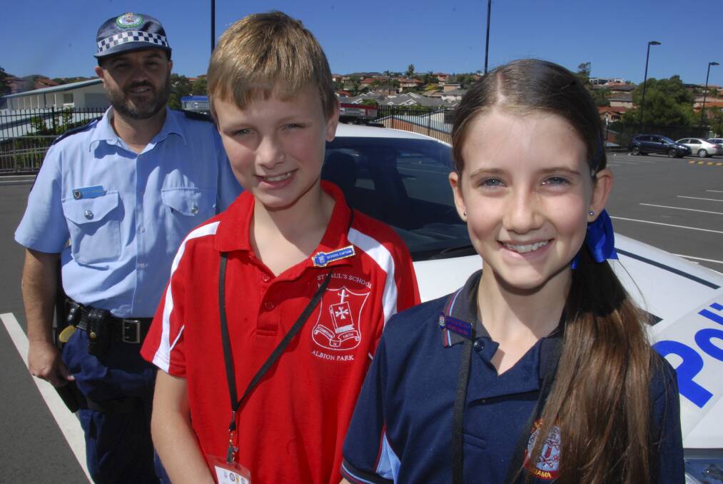 Lake Illawarra senior constable and Youth Liason Officer Scott Burgess with Joshua Patino from St Paul's Albion Park and Georgia Richards from Ss Peter and Paul's. Picture Eliza Winkler