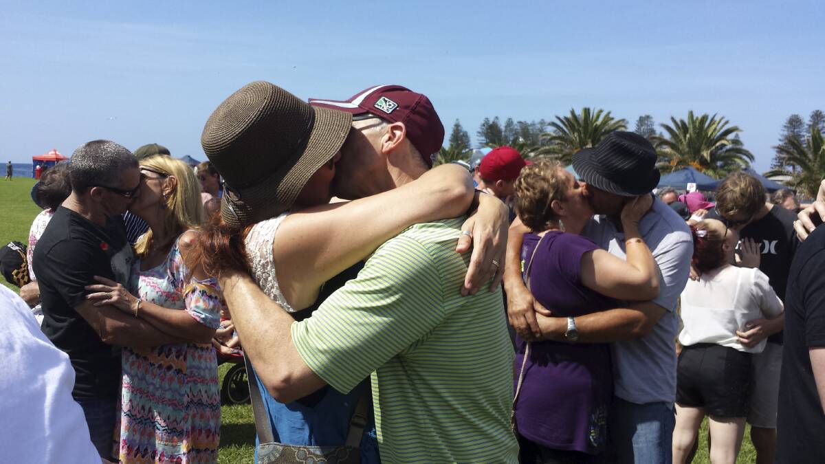 Couples at Black Beach on Sunday attempt to break the world record for kissing for 60 seconds, with 54 registered couples falling short of a world record. Picture: GREG TOTMAN