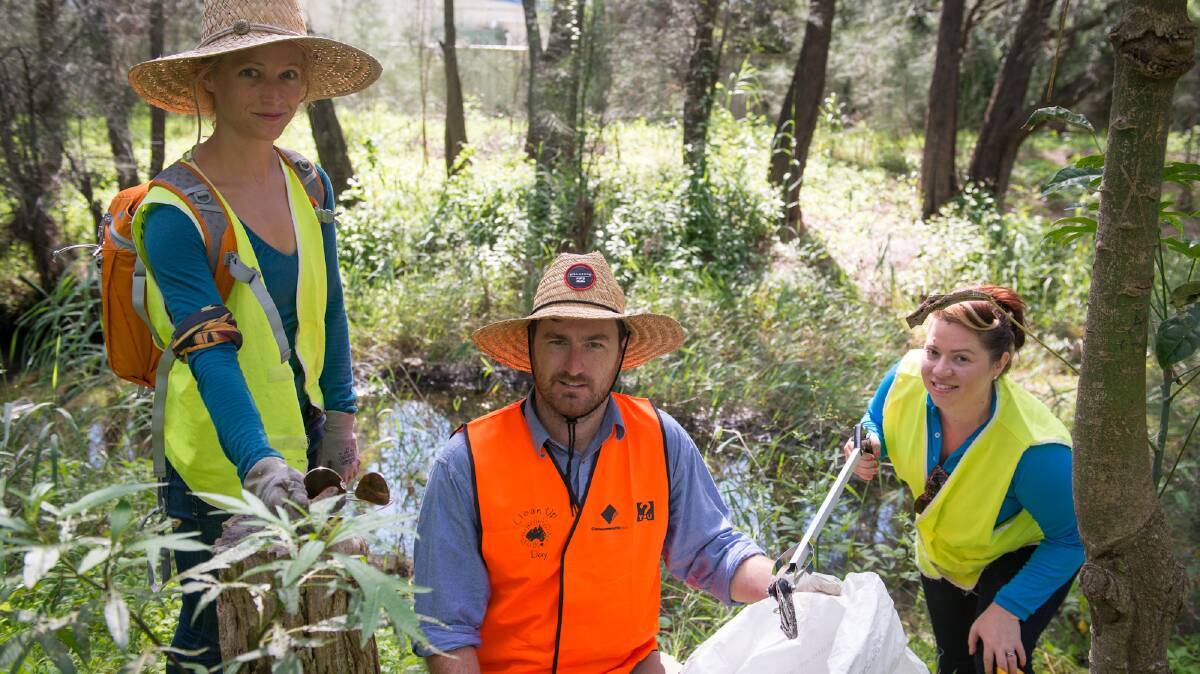 Brianna Brandan, Adam Woods and Jessica Foster work at Oaky Creek last Wednesday as part of Clean Up Australia Day. Picture: ALBEY BOND