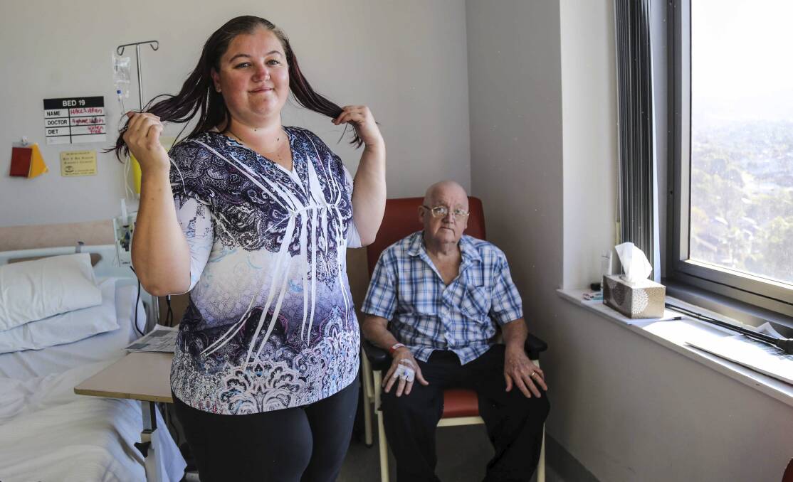Albion Park's Amanda Halls shows off her hair to her father, Allan, this week before she shaves it all off next weekend. Picture: GEORGIA MATTS