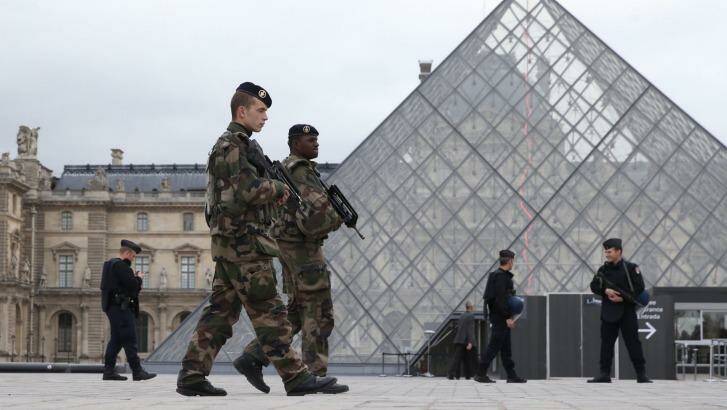 French military and police patrol the Louvre in Paris, France as Australian authorities increase the travel warnings for France and Belgium. Photo: Andrew Meares