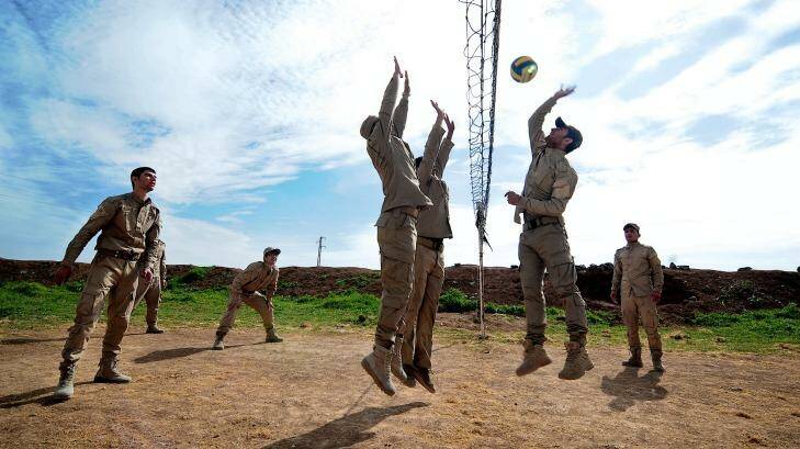 New conscripts to Rojava's army play volleyball during a break from training at an abandoned Syrian military base near Ramalan.   Photo: Fadi Yeni Turk