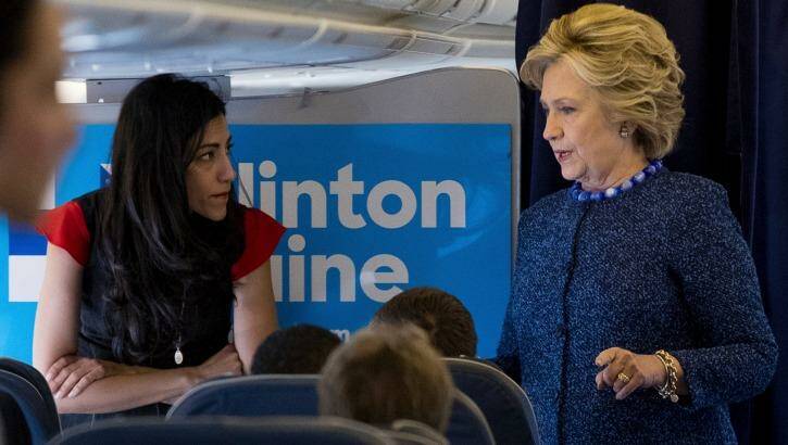 Mrs Clinton speaks with senior aide Huma Abedin aboard her presidential campaign plane. Photo: Andrew Harnik