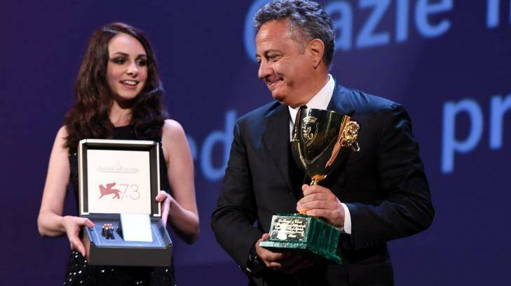 A Jaeger-LeCoultre Unique Reverso watch is held to go along with as Paolo Del Brocco (R) accepts the Coppa Volpi for Best Actress for Emma Stone for La La Land during the Venice's closing ceremony. Photo: Ian Gavan