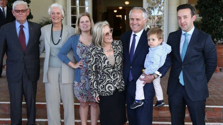Tom Hughes (left) with Prime Minister Malcolm Turnbull and his family at Government House following his swearing in. Photo: Andrew Meares