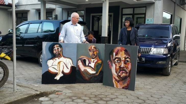 Australian lawyer Julian McMahon with three self-portraits by Sukumaran: "The 72 hours just started", "Strange Day" and "Our new prints: A bad sleep last night". Photo: Amilia Rosa