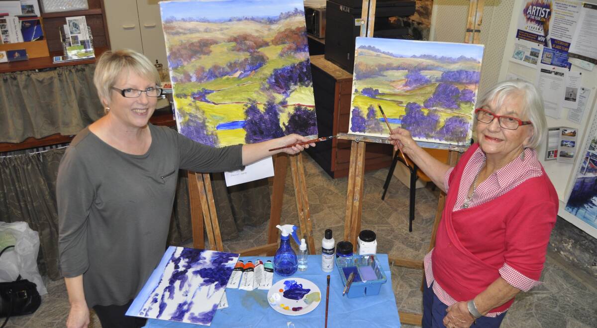Kiama Art Society teacher Kathy Karas (left) and long-time member, Jamberoo resident Mary-Jane Burke get ready to showcase their works at the group's latest members' exhibition. Picture: BRENDAN CRABB