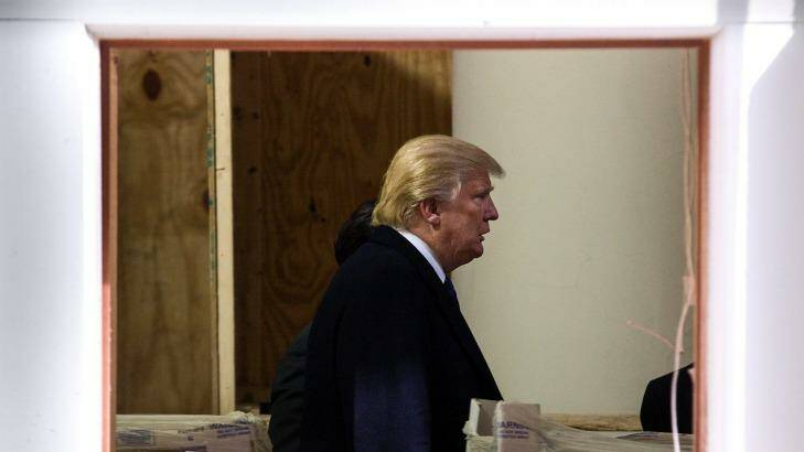Donald Trump walks through construction in the lobby of the Old Post Office building in Washington, now being developed into a Trump International Hotel. Photo: Doug Mills