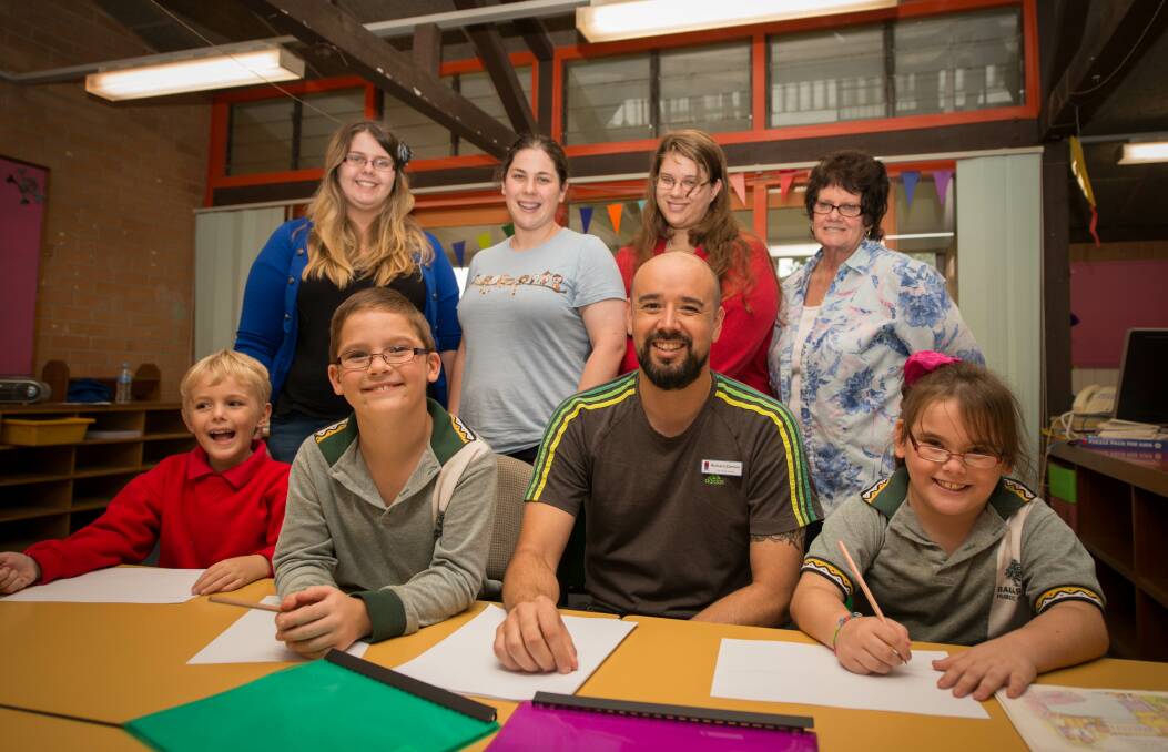 Barrack Heights Public School Learning Club volunteers Emily Jarrett, Justine Cotter, Allison Cotter and Moira Smythe (rear), with Nate Jones, Bradley Tschutura, Smith Family Learning for Life program co-ordinator Richard Zamora and Emiley Tschutura. Picture: ALBEY BOND
