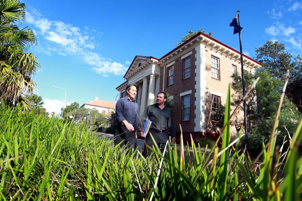 CCTV will be installed in key areas of the CBD, including Manning Street. Pictured are Kiama Council's John Holland and Nick Guggisberg. Picture: SYLVIA LIBER