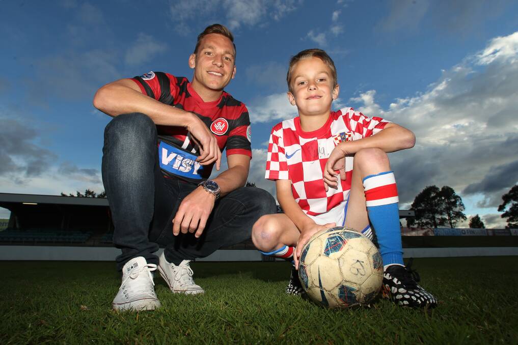 Brendon Santalab and eight-year-old Kristian Butkovic are looking forward to the 40th annual Australia and New Zealand Croatian Soccer Tournament in Wollongong from October 2-5. Picture: GREG TOTMAN