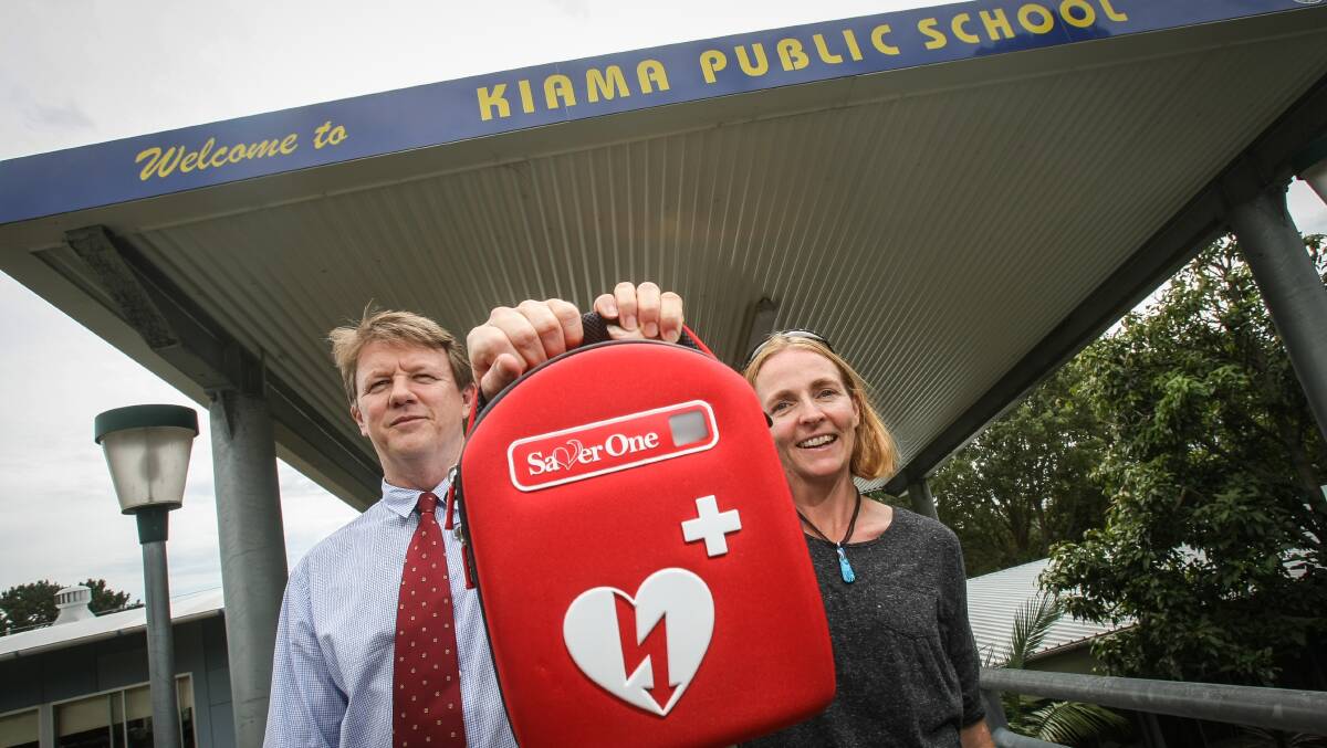 Kiama Public School principal Michael Honeywood and P&C president Amanda Koorey with the school's new defibrillator. Picture: DYLAN ROBINSON