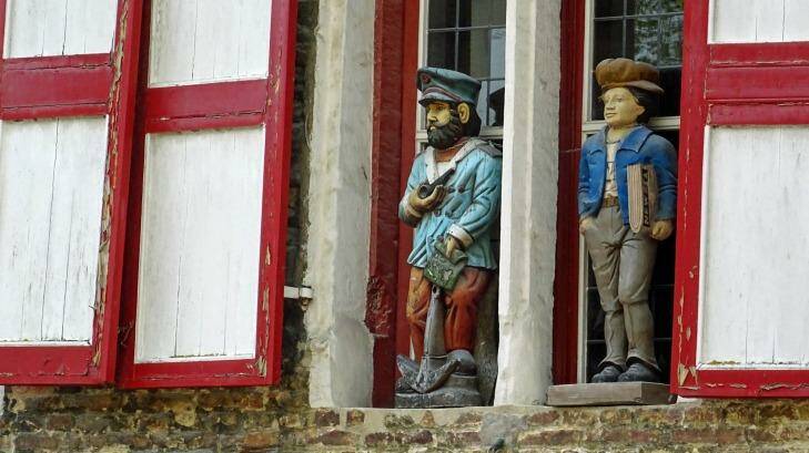 Carved wooden figures on a house in Bruges, Belgium. Photo: Brian Johnston