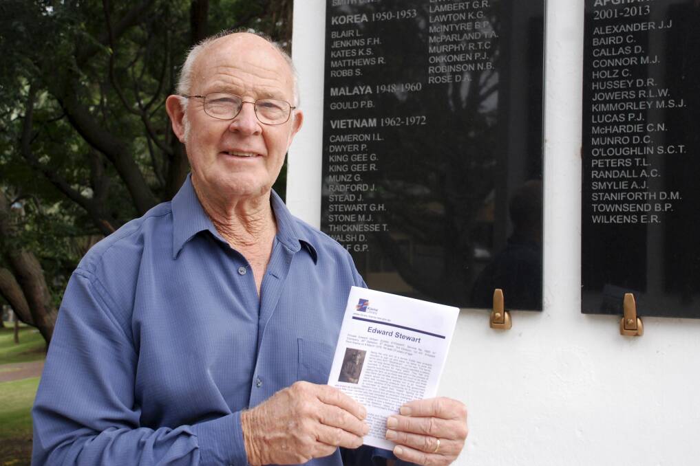 Kiama's Brian Stewart with a copy of his father's biography and in front of the Kiama War Memorial in front of his brother Garry's name on the memorial. Picture: DAVID HALL