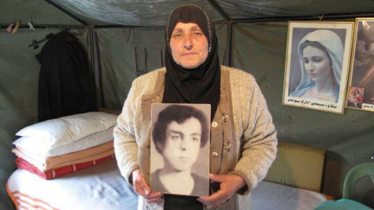 Majida Bashasha, with a photo of her missing brother Ahmad, in the tent she lives in outside the United Nations offices in Beirut. Photo: Ruth Pollard