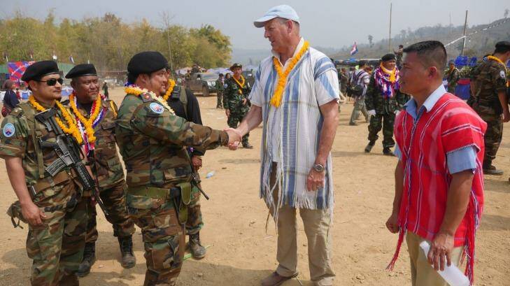 Mr Simpkins greets Karen guerrillas at their Revolution Day event in Myanmar. Photo: Steve Sandford