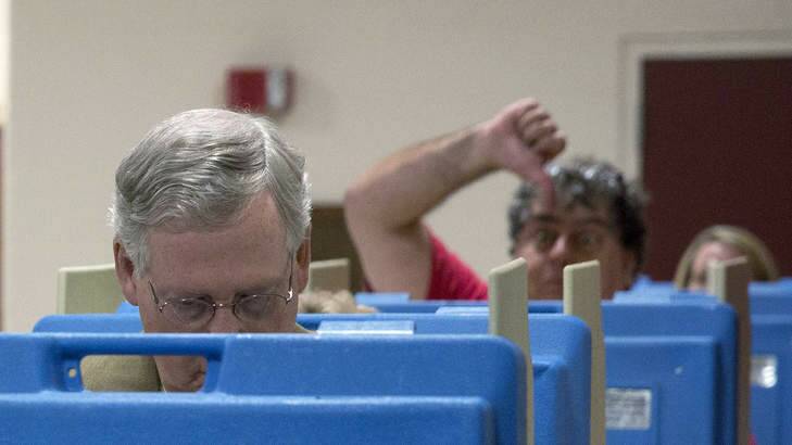 Voter photobombs Senate Minority Leader US Senator Mitch McConnell in the polls in Kentucky. McConnell's battle for keep his senate seat is one of the most closely watched races in the midterm elections. Photo: Getty